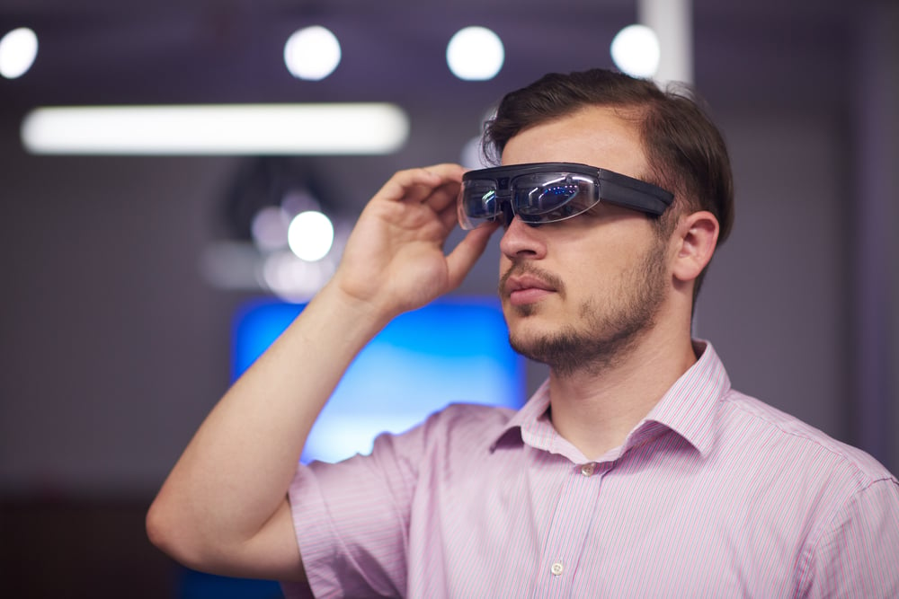 young man using virtual reality gadget computer technology glasses